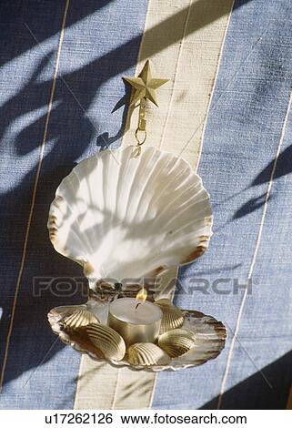 Close-up of hand-made seashell wall-sconce with lighted candle View Large Photo Image Stock Photograph - Close-up of hand-made seashell wall-sconce with lighted candle. Fotosearch