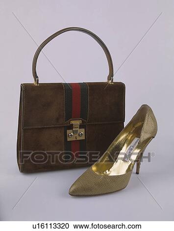 Stock Image - Close-up of handbag and Manolo Blahnik stiletto-healed bronze lizard-skin shoe. Fotosearch