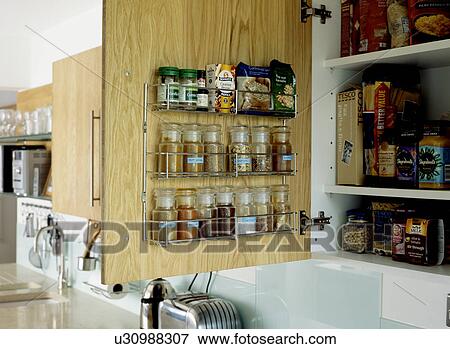 Close-up of herb and spice storage jars on rack on open cupboard door View Large Photo Image Stock Photo - Close-up of herb and spice storage jars on rack on open cupboard door. Fotosearch
