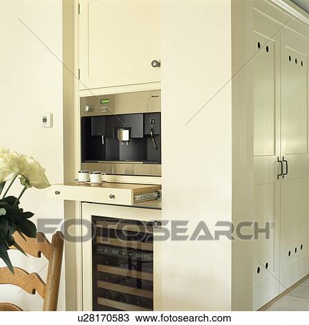 Close-up of integral coffee-machine above pull-out shelf in modern white kitchen View Large Photo Image Stock Image - Close-up of integral coffee-machine above pull-out shelf in modern white kitchen. Fotosearch