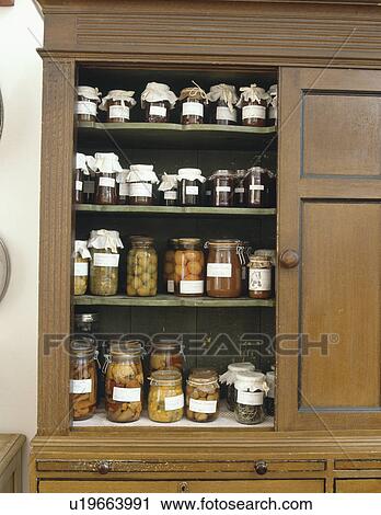 Close-up of jars of home-made jam and preserves in antique larder cupboard View Large Photo Image Stock Image - Close-up of jars of home-made jam and preserves in antique larder cupboard. Fotosearch