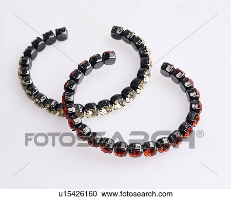 Stock Image - Close-up of jewelled bangles. Fotosearch