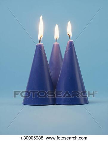 Close-up of lighted blue conical candles View Large Photo Image Stock Photo - Close-up of lighted blue conical candles. Fotosearch