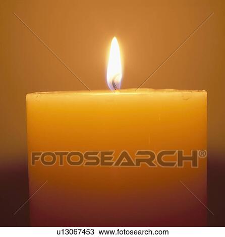 Stock Image - Close-up of lighted candle. Fotosearch