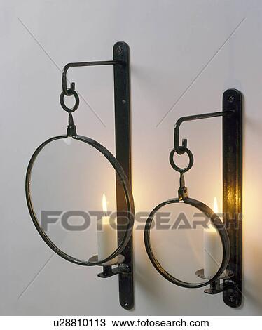 Close-up of lighted candles in circular wrought iron wall-sconces View Large Photo Image Stock Image - Close-up of lighted candles in circular wrought iron wall-sconces. Fotosearch