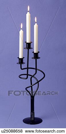 Close-up of lighted white candles in black wrought-iron candlestick View Large Photo Image Stock Photo - Close-up of lighted white candles in black wrought-iron candlestick. Fotosearch