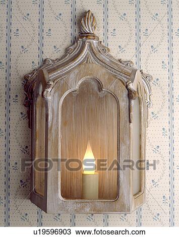 Stock Image - Close-up of limed wood lantern wall-light. Fotosearch