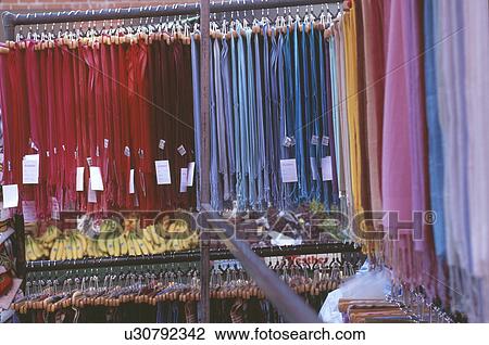 Stock Image - Close up of market stall selling colourful scarves with bananas and grapes. Fotosearch