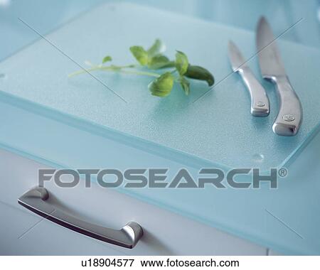 Close-up of metal knives on turquoise glass chopping board View Large Photo Image Stock Photo - Close-up of metal knives on turquoise glass chopping board. Fotosearch