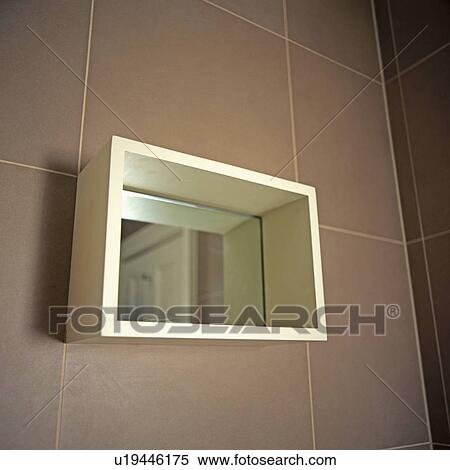 Close-up of mirror on brown wall tiles View Large Photo Image Stock Photography - Close-up of mirror on brown wall tiles. Fotosearch