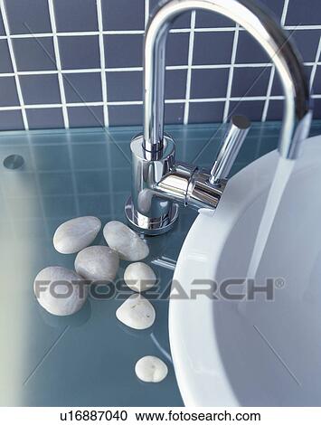 Stock Image - Close-up of mixer tap pouring water into bath. Fotosearch