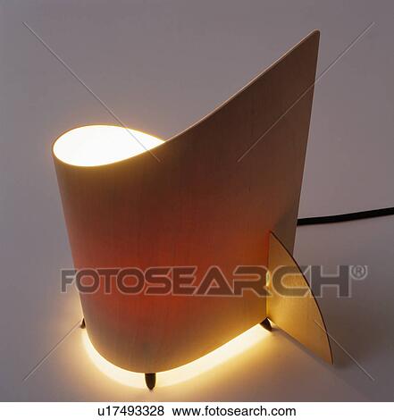 Stock Photo - Close-up of modern curved wood lamp. Fotosearch