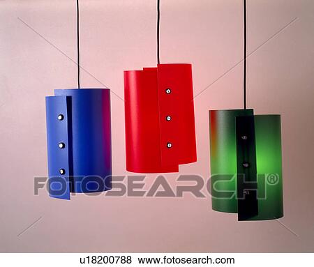 Stock Photo - Close-up of modern red, blue and green lampshades on ceiling lights. Fotosearch