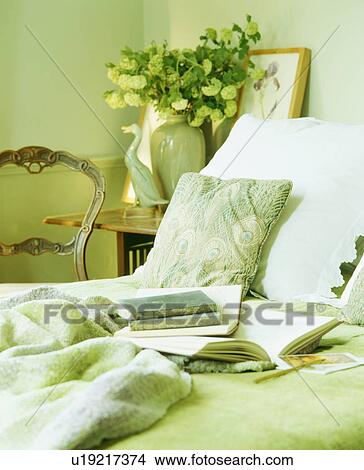 Close-up of notebooks on bed with pastel green throw View Large Photo Image Picture - Close-up of notebooks on bed with pastel green throw. Fotosearch