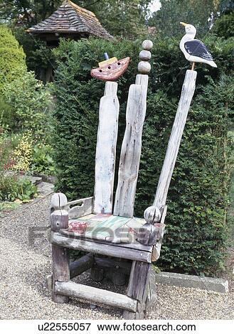 Close-up of novelty hand-carved sculptural chair in English garden View Large Photo Image Stock Photo - Close-up of novelty hand-carved sculptural chair in English garden. Fotosearch