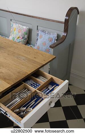 Close-up of oak table with cutlery stored in open drawer View Large Photo Image Stock Image - Close-up of oak table with cutlery stored in open drawer. Fotosearch