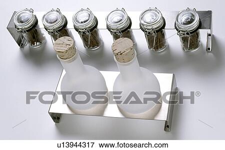 Close-up of opaque glass bottles with cork stoppers with group of lidded glass jars View Large Photo Image Stock Photo - Close-up of opaque glass bottles with cork stoppers with group of lidded glass jars. Fotosearch