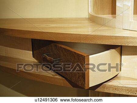 Stock Photograph - Close-up of open drawer in pale wood unit. Fotosearch