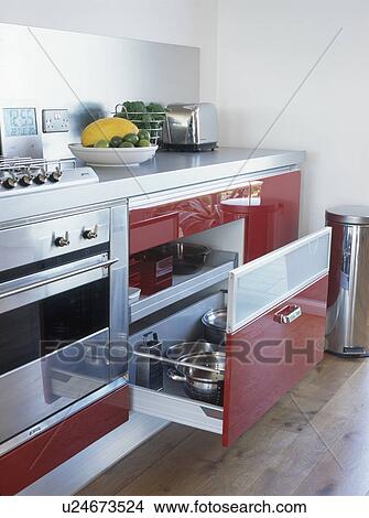 Close-up of open pan storage drawer beside oven in modern kitchen View Large Photo Image Picture - Close-up of open pan storage drawer beside oven in modern kitchen. Fotosearch