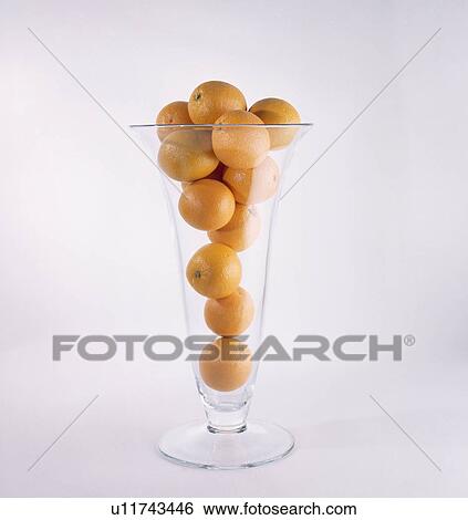 Close-up of oranges in tall stemmed vase View Large Photo Image Stock Photograph - Close-up of oranges in tall stemmed vase. Fotosearch