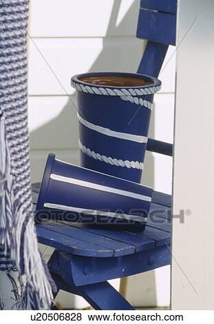 Close-up of painted blue+white pots on blue chair View Large Photo Image Stock Photo - Close-up of painted blue+white pots on blue chair. Fotosearch