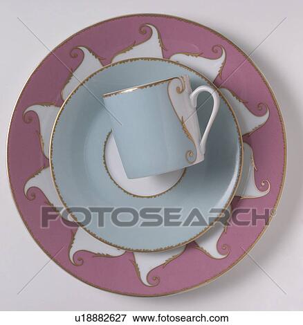 Stock Photo - Close-up of pale blue cup and saucer on patterned pink and white plate. Fotosearch