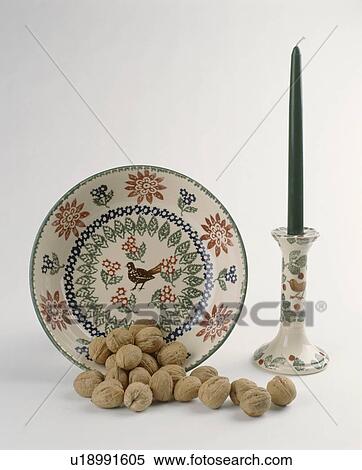 close-up of patterned pottery plate and candlestick with walnuts View Large Photo Image Stock Photography - close-up of patterned pottery plate and candlestick with walnuts. Fotosearch