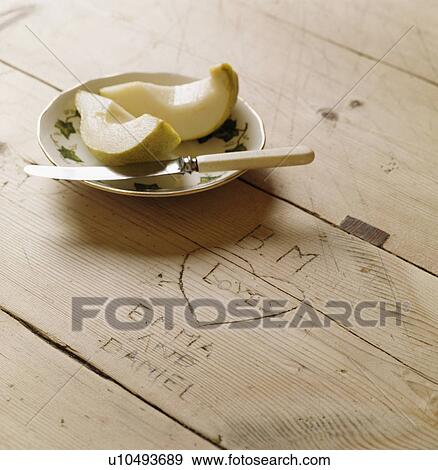Close-up of plate of apple slices on wooden table View Large Photo Image Stock Photo - Close-up of plate of apple slices on wooden table. Fotosearch