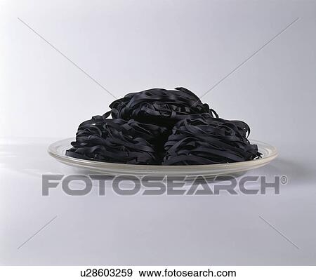 Close-up of plate of black pasta View Large Photo Image Stock Photo - Close-up of plate of black pasta. Fotosearch