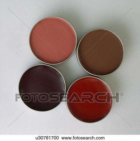 Stock Image - Close-up of pots of cream blusher. Fotosearch