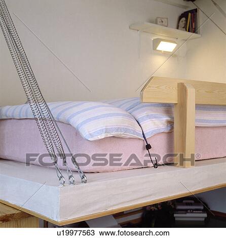 Close-up of pull-down bed with metal fixings in sleeping area in small studio apartment View Large Photo Image Stock Image - Close-up of pull-down bed with metal fixings in sleeping area in small studio apartment. Fotosearch