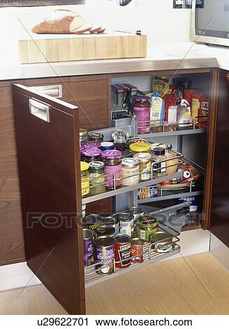 Stock Image - Close-up of pull-out storage shelves in modern kitchen. Fotosearch