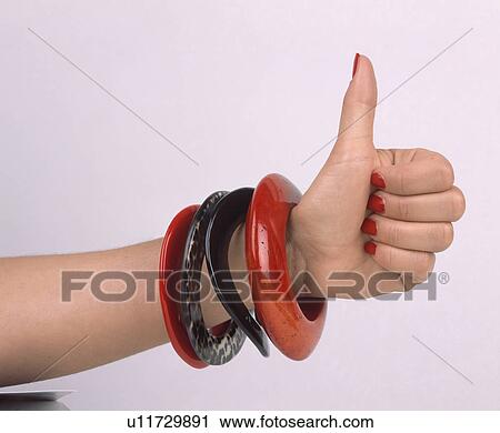 Close-up of red and black bangles on woman's arm View Large Photo Image Stock Image - Close-up of red and black bangles on woman's arm. Fotosearch