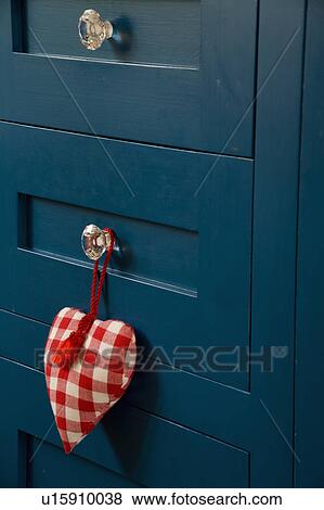 Close-up of red-checked fabric heart on glass handle on kitchen drawers View Large Photo Image Stock Photo - Close-up of red-checked fabric heart on glass handle on kitchen drawers. Fotosearch