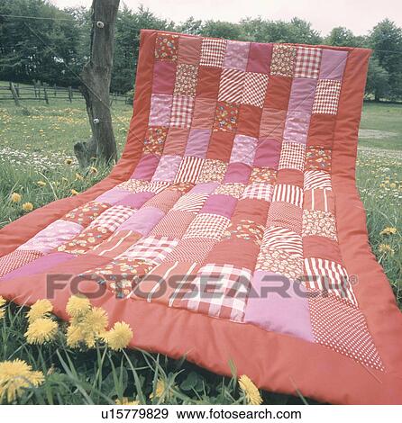Close-up of red patchwork quilt in field View Large Photo Image Stock Photo - Close-up of red patchwork quilt in field. Fotosearch