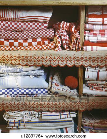 Close-up of red+white checked quilts and line on shelves with scalloped trimming View Large Photo Image Picture - Close-up of red+white checked quilts and line on shelves with scalloped trimming. Fotosearch