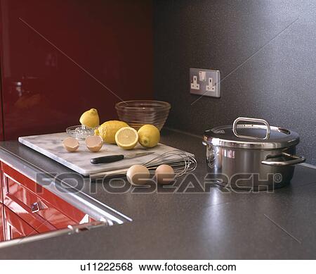 Close-up of saucepan beside lemons on marble slap on dark grey Corian worktop View Large Photo Image Stock Photo - Close-up of saucepan beside lemons on marble slap on dark grey Corian worktop. Fotosearch