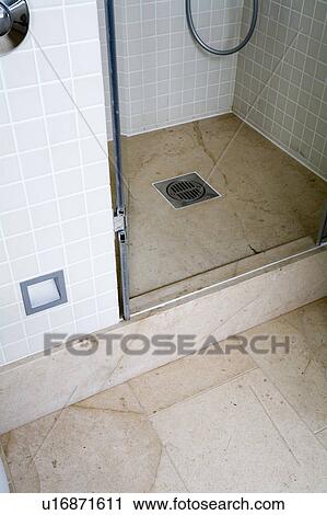 Stock Image - Close-up of shower with tiled floor. Fotosearch