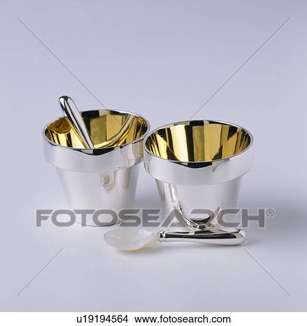 Close-up of silver and gold salt-pots with silver and mother-of-pearl spoons View Large Photo Image Picture - Close-up of silver and gold salt-pots with silver and mother-of-pearl spoons. Fotosearch