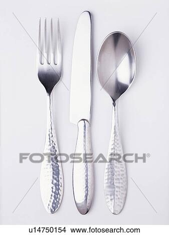 Picture - Close-up of silver knife and fork with spoon. Fotosearch