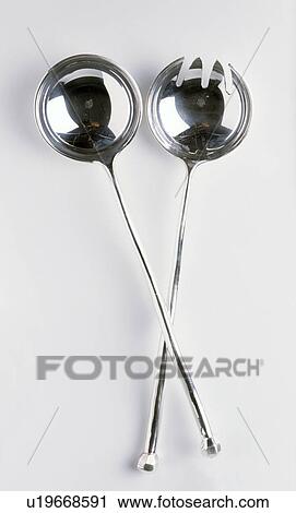 Stock Image - Close-up of silver salad servers. Fotosearch