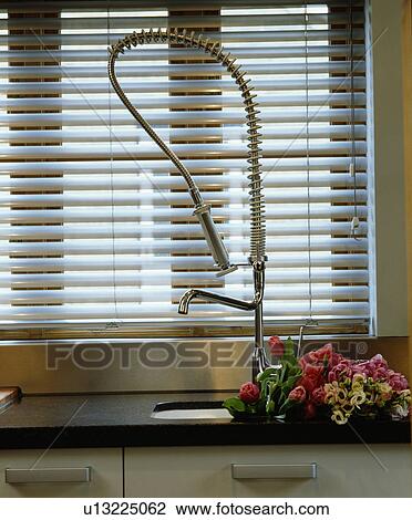 Close-up of slatted blind above flexible steel tap and underset sink View Large Photo Image Stock Image - Close-up of slatted blind above flexible steel tap and underset sink. Fotosearch