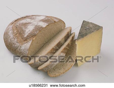 Close-up of slice of cheese with loaf of home-made brown bread View Large Photo Image Stock Image - Close-up of slice of cheese with loaf of home-made brown bread. Fotosearch