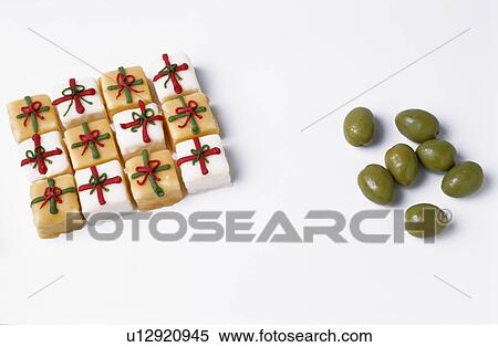 Close-up of small decoratively iced square cakes beside group of green olives View Large Photo Image Stock Photography - Close-up of small decoratively iced square cakes beside group of green olives. Fotosearch