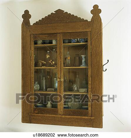 Close-up of small wooden cupboard with bottle collection View Large Photo Image Stock Image - Close-up of small wooden cupboard with bottle collection. Fotosearch