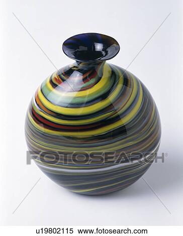 Stock Photography - Close-up of spherical blown glass vase with multi-coloured stripes. Fotosearch
