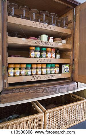 Close-up of spice and herb jars on old pine millinery cupboard above large storage baskets View Large Photo Image Stock Photo - Close-up of spice and herb jars on old pine millinery cupboard above large storage baskets. Fotosearch