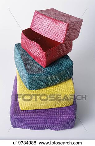 Close-up of stack of colourful small lidded raffia boxes View Large Photo Image Stock Photo - Close-up of stack of colourful small lidded raffia boxes. Fotosearch