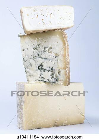 Picture - Close-up of stack of three cheeses. Fotosearch