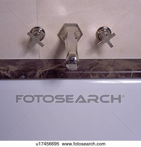 Stock Photography - Close-up of stainless steel bath taps. Fotosearch